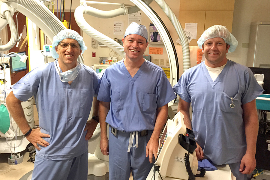 Shunyata's Grant Samuelson smiling with two doctors after resting CIS tech
